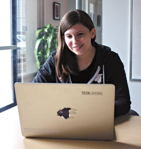 Amanda Harlin, co-founder of Techlahoma, works while repping Techlahoma merch.